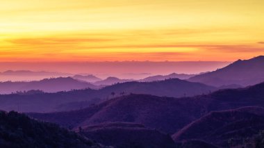 Landscape view sunrise over mountains Ban I-Tong, Pilok, between border Thai -  Myanmar at Thong Pha Phum National park, Kanchanaburi, Thailand.  clipart