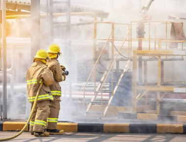 Action professional firemans brave buddy team assistance in yellow fire fighter uniform holding fire hose nozzle spraying foam  water control fighting  clipart