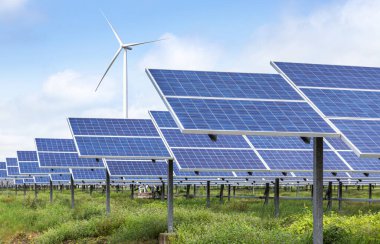 Melez enerji santrali istasyonunda elektrik üreten çok kristalli silikon güneş panelleri ve rüzgar türbini sıraları dizisi 