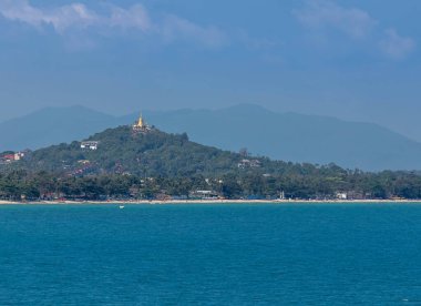 Landscape view of Chaweng beach with golden pagoda wat khao hua jook temple on top of the hill at Koh Samui island ,Thailand clipart