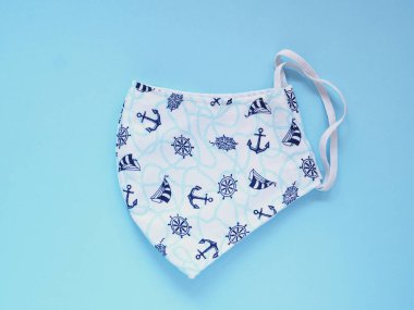 Üst görünüm, Mavi tonlu yüz maskesi kirliliği ve virüsleri önlemek için. Mavi arka planda pamuk muslin el yapımı. Sağlık, Sağlık ve Yeni Normal Konsepti. Metnin için boşluk kopyala