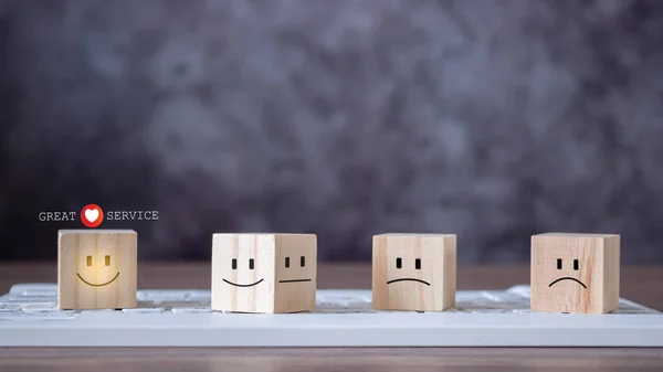 The best service, wooden blocks with symbol smile face and heart shape on keyboard. Great serivce customer satisfaction survey. An excellent rating for the quality of a service or product