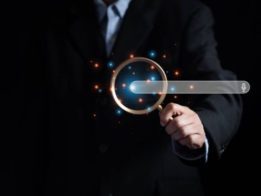 (Arama motoru optimizasyonu. İş adamı sanal ekranda arayüz arama motoru çubuğunda büyüteç cam odak simgesi kullanır. İnternet veri bilgileri taranıyor.