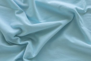 Dalgalı yeşil pamuk kumaş. Güzel pürüzsüz, zarif, soyut arkaplan tasarımı.  