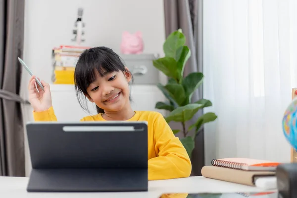 stock image Asian little girl taking class on line and happy for Homeschool Quarantine coranavirus pandemic concept