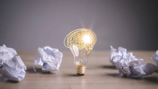 Education concept image. Creative idea and innovation. Crumpled paper as light bulb metaphor over