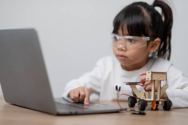 Asyalı öğrenciler evlerinde robot arabaları ve elektronik tahta kablolarını STEM, STEAM, matematik mühendisliği, bilim teknolojisi bilgisayar kodlarını çocuk konsepti için robotikte kodlayarak öğreniyorlar..