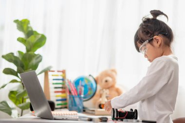 Asyalı öğrenciler evlerinde robot arabaları ve elektronik tahta kablolarını STEM, STEAM, matematik mühendisliği, bilim teknolojisi bilgisayar kodlarını çocuk konsepti için robotikte kodlayarak öğreniyorlar..