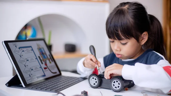 Asia students learn at home in coding robot cars and electronic board cables in STEM, STEAM, mathematics engineering science technology computer code in robotics for kids concept