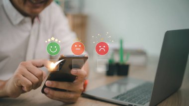 man use smartphone choosing green happy smile face icon. feedback rating and positive customer review experience, satisfaction survey. mental health assessment. world mental health day concept