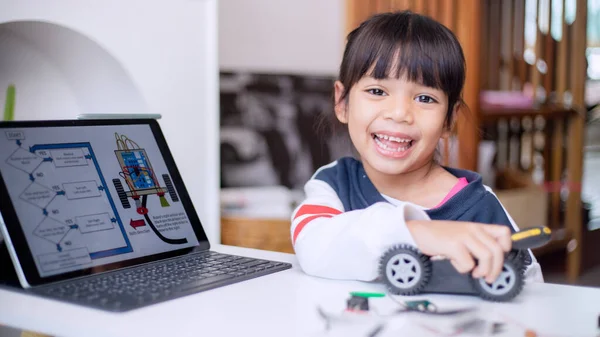 Asia students learn at home in coding robot cars and electronic board cables in STEM, STEAM, mathematics engineering science technology computer code in robotics for kids concept