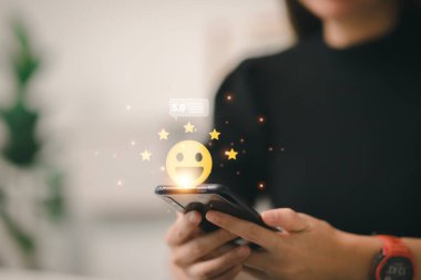 hand touching on five star icon and happy smile face for feedback review satisfaction service, Customer service experience and business satisfaction survey.