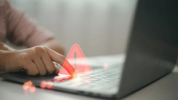 Computer notification error maintenance concept. programmer, or developer using a computer laptop with a triangle warning exclamation red sign trouble caution.