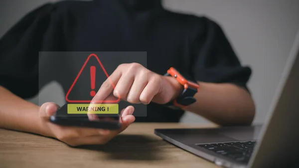 developer using computer laptop with triangle caution warning sign for notification error and maintenance concept.