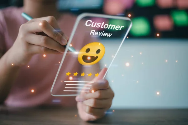 stock image Businesswoman pressing face emoticon on virtual touch screen at smartphone .Customer service evaluation concept.