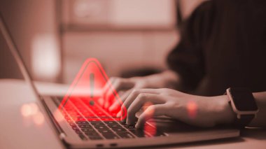 developer using computer laptop with triangle caution warning sign for notification error and maintenance concept.