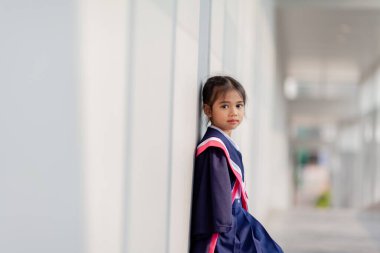 Happy Asian girls in graduation gowns on their graduation day at school.Graduation concept with copy space.	