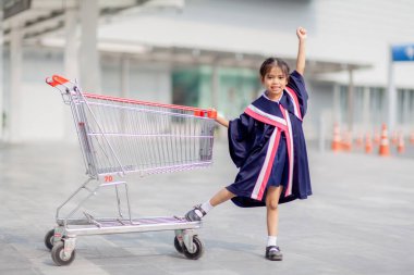 Happy Asian girls in graduation gowns on their graduation day at school.Graduation concept with copy space.	