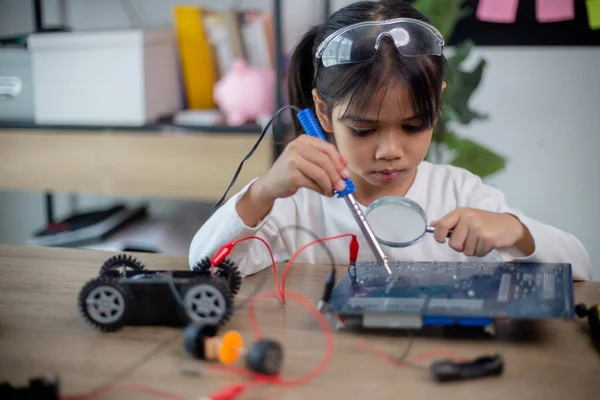 Asia students learn at home in coding robot cars and electronic board cables in STEM, STEAM,
