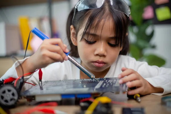 Asia students learn at home in coding robot cars and electronic board cables in STEM, STEAM,