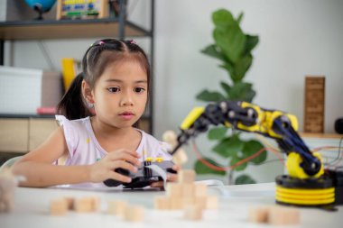 BTMM eğitim konsepti. Asyalı öğrenciler evde robot kollarını STEM 'de kodlayarak öğreniyorlar, matematik mühendisliği bilim teknolojisi bilgisayar kodları çocukların kavramları için robotik.