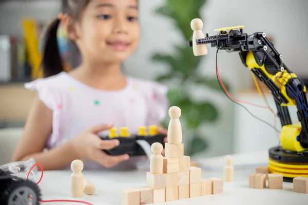STEM education concept. Asian students learn at home by coding robot arms in STEM, mathematics engineering science technology computer code in robotics for kids\' concepts