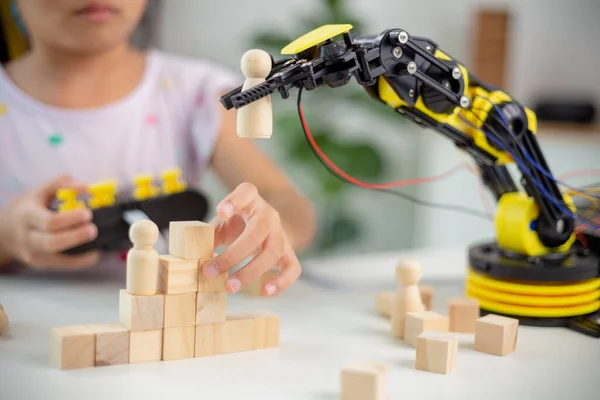 STEM education concept. Asian students learn at home by coding robot arms in STEM, mathematics engineering science technology computer code in robotics for kids' concepts