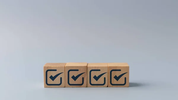 Checklist, Check mark icons for the jobs list on the wooden blocks. Task lists, Surveys, Assessments, Lists, Confirm items, Quality Control. Goals achievement business success.