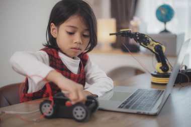 BTMM eğitim konsepti. Asyalı öğrenciler evde robot kollarını STEM 'de kodlayarak öğreniyorlar, matematik mühendisliği bilim teknolojisi bilgisayar kodları çocukların kavramları için robotik..