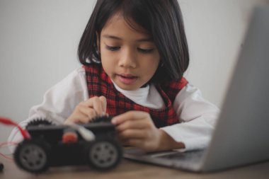 BTMM eğitim konsepti. Asyalı öğrenciler evde robot kollarını STEM 'de kodlayarak öğreniyorlar, matematik mühendisliği bilim teknolojisi bilgisayar kodları çocukların kavramları için robotik..
