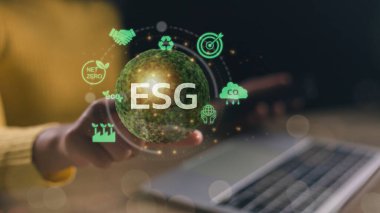 ESG environmental, social, and governance. Women touch the ESG icon on the green globe for the world sustainable environment concept.	