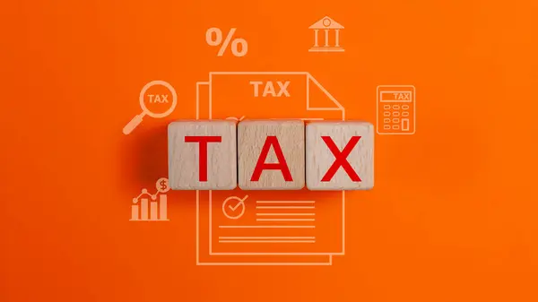 Tax words on wooden cubes and tax form icons. Tax payment reminder or annual taxation concept