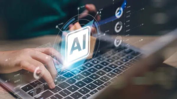 Bir kişi dizüstü bilgisayarında Al yazan mavi bir ekranla yazı yazıyor. Teknoloji kavramı ve yapay zekanın günlük hayatımızdaki önemi