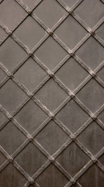 Close-Up of an Antique Gray Metal Door with a Geometric Lattice Design - Texture