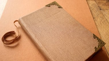 Closed Vintage Book with Decorative Textured Cover and Gold Metal Corners