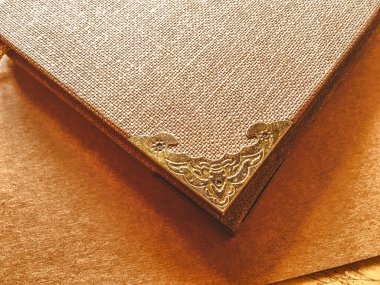 Close-Up of a Gold Metal Decorative Corner on an Antique Brown Textured Book Cover Decoupage