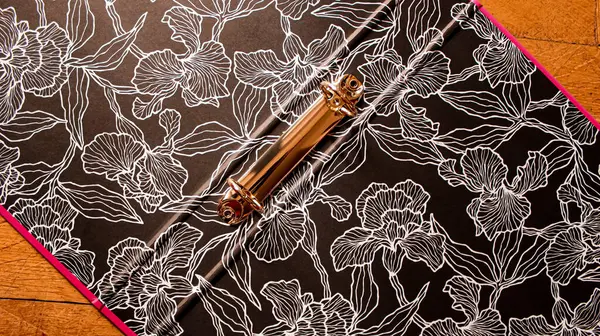 Empty Open Binder with Black Floral-Patterned Inner Lining and Gold Metal Clasp