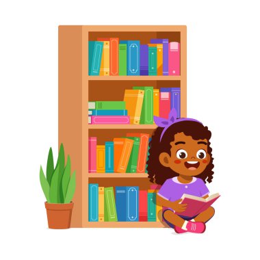 Küçük çocuk kütüphanede kitap okuyor.