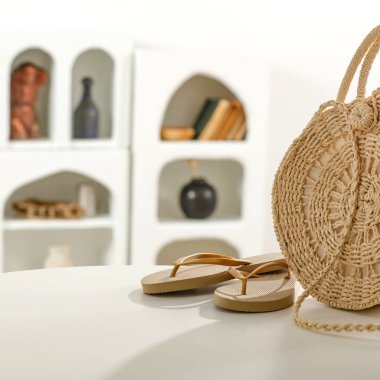 Hasır şapkalı sepet çantası, aksesuar çantası, hasır sepet ve beyaz mobilya arka planında aksesuarlar, yakın plan.