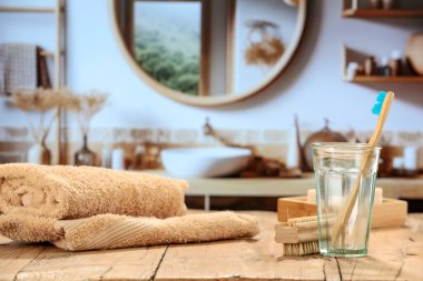 Ahşap arka planda spa aksesuarlarının bileşimi ve bulanık banyo içi.