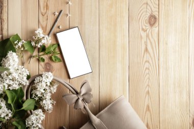 Bahar çiçekleri, cep telefonu ve kadın çantası. Anneler Günü için mükemmel bir tasarım. Metin veya ürün için akıllı telefon ekran kopyalama alanı.