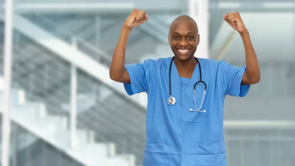 Motivated cheering black doctor or male nurse at hospital