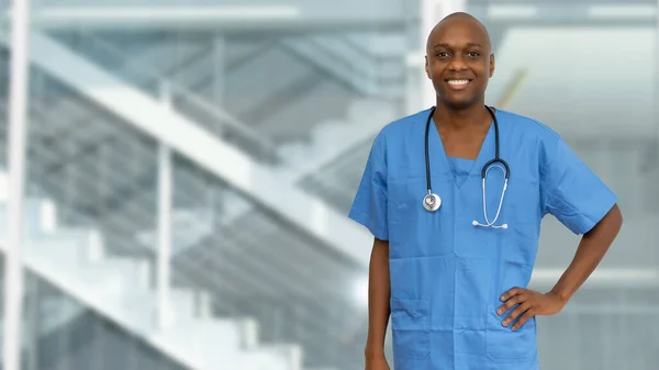 Laughing black doctor or male nurse at hospital