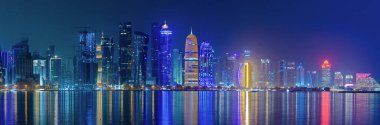 Doha, Qatar- May 5,2022 : Doha skyline with many towers during the night.