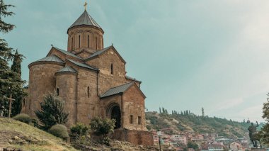 Tbilisi,Georgia-June 06.2024 :Metekhi Virgin Mary Assumption Church,The Metekhi church of the Nativity of the Mother of God, known simply as Metekhi, is a Georgian Orthodox Christian church located on the left bank of the river Kura. clipart