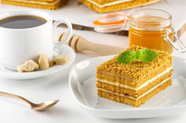 Homemade Honey cake. Honey cake Medovik, layer cake on white plate. Closeup view. sweet dessert cake. Slice of layered honey cake selective focus.