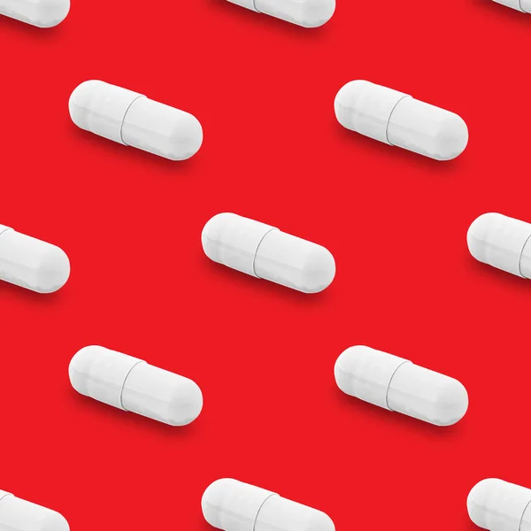 Gel capsule seamless pattern. White capsule shaped medicine. pharmacy concept. food supplement. Capsule pills pattern on a red background