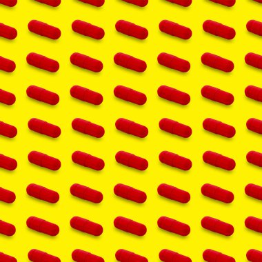 Gel capsule seamless pattern. Red capsule shaped medicine. pharmacy concept. food supplement. Capsule pills pattern on a yellow background