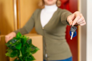 Starting new life. Overjoyed woman hold keys from new apartment or home. new life starts now. Excited woman proud of becoming homeowner first time. loan, mortgage concept