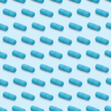 Gel capsule seamless pattern. Blue capsule shaped medicine. pharmacy concept. food supplement. Capsule pills pattern on a light blue background